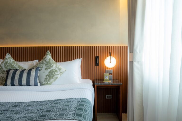Deluxe King — headboard and globe lamp detail